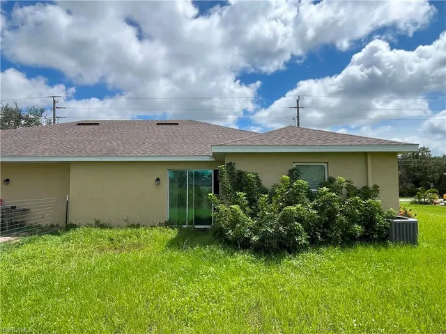 a front view of a house with a garden and yard