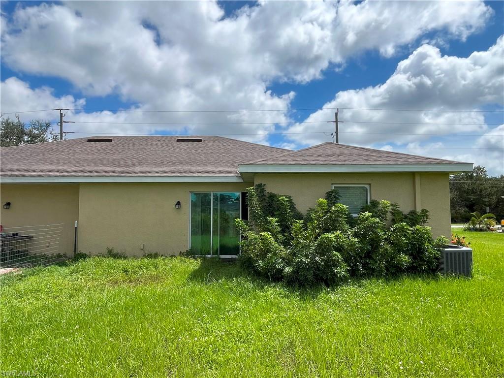 1187 Highlands Road Punta Gorda, FL 33983 - Photo 20 of 21 a front view of a house with garden