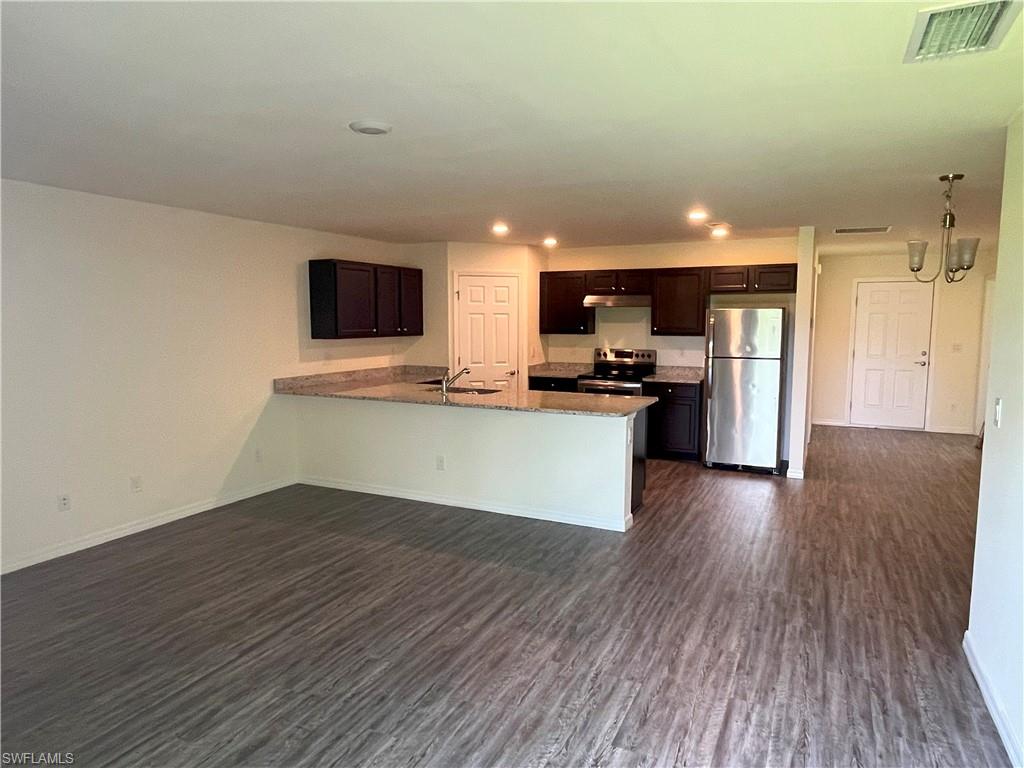 1187 Highlands Road Punta Gorda, FL 33983 - Photo 6 of 21 a view of kitchen with sink microwave and refrigerator