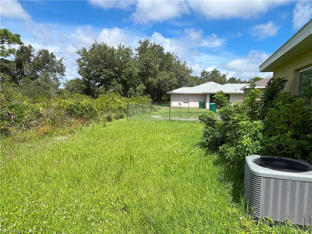 1187 Highlands Road Punta Gorda, FL 33983 - Photo 9 of 21 a view of a backyard with plants and a garden