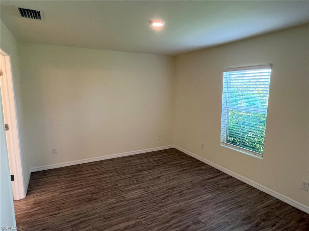 1187 Highlands Road Punta Gorda, FL 33983 - Photo 10 of 21 an empty room with wooden floor and windows