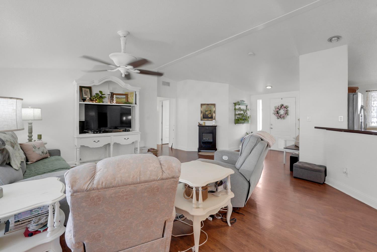 1459 Standiford, Unit 92 Modesto, CA 95350 - Photo 16 of 19 a living room with furniture a flat screen tv and a table