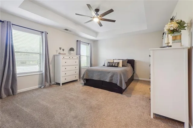a spacious bedroom with a bed and a cabinets