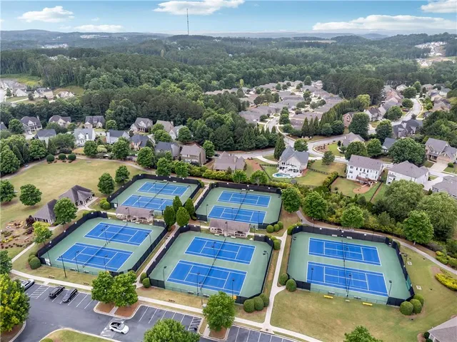 an aerial view of residential houses with outdoor space and lake view
