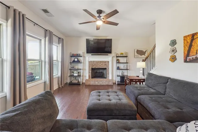 a living room with furniture a flat screen tv and a fireplace