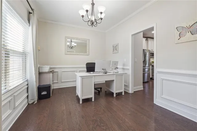 a view of a workspace with furniture and window