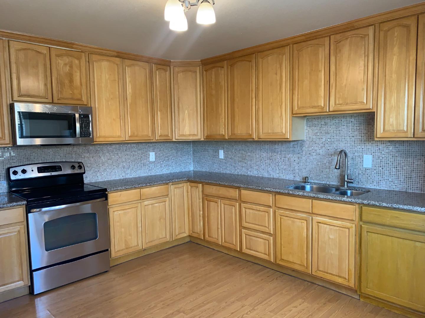 149 Adler Avenue Campbell, CA 95008 - Photo 7 of 12 a kitchen with granite countertop cabinets stainless steel appliances and sink