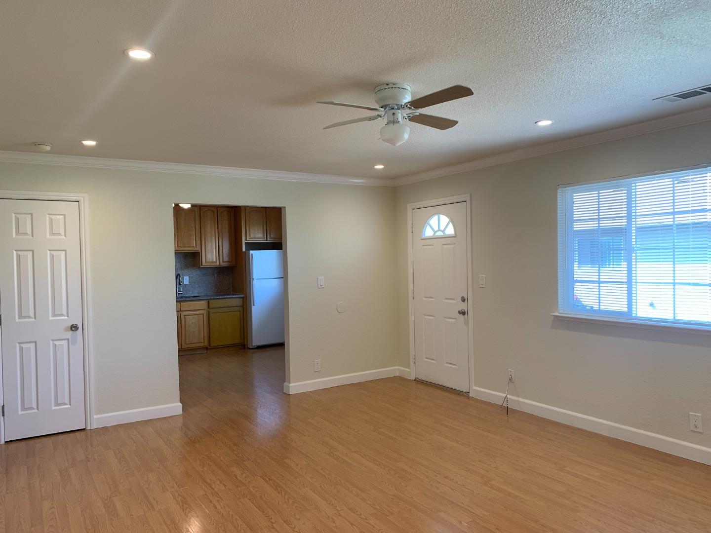 149 Adler Avenue Campbell, CA 95008 - Photo 8 of 12 an empty room with wooden floor and windows
