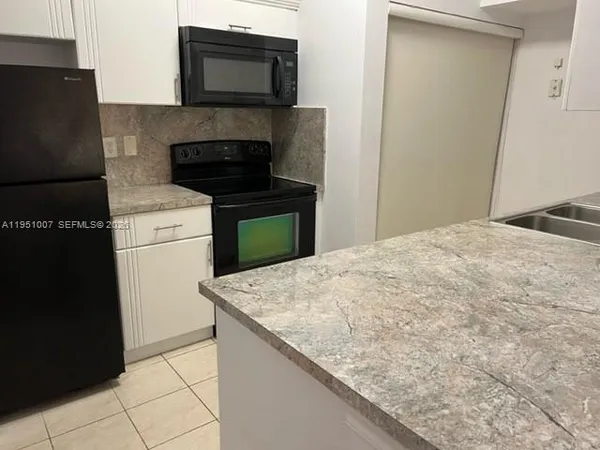 a kitchen with a stove and a microwave