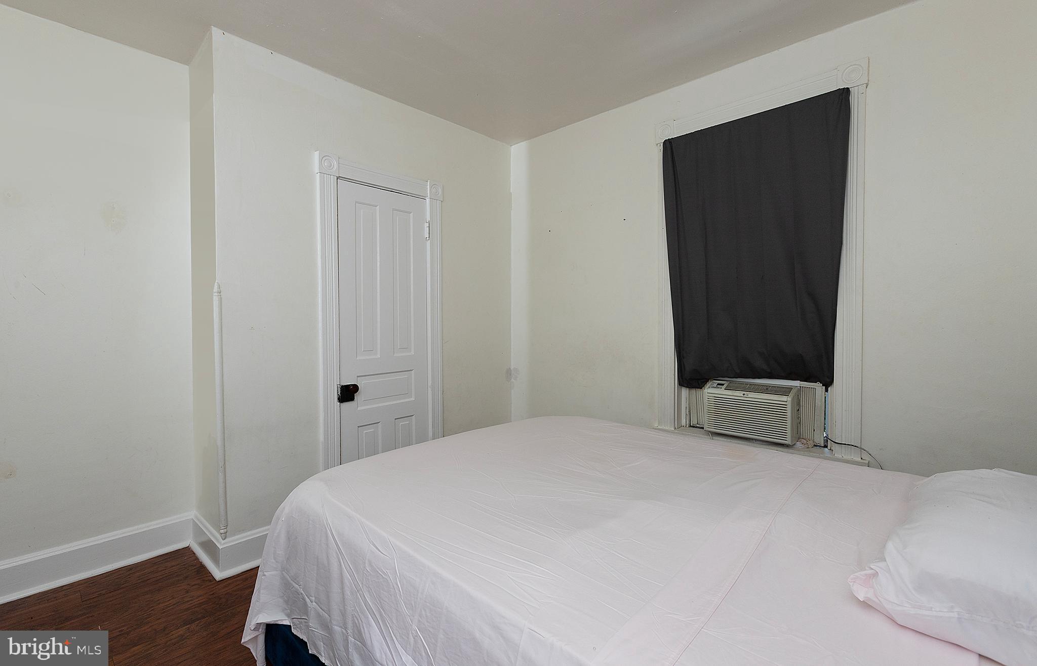 1342 State Street, Unit 2R Harrisburg, PA 17103 - Photo 13 of 17 a bedroom with a bed and wooden floor