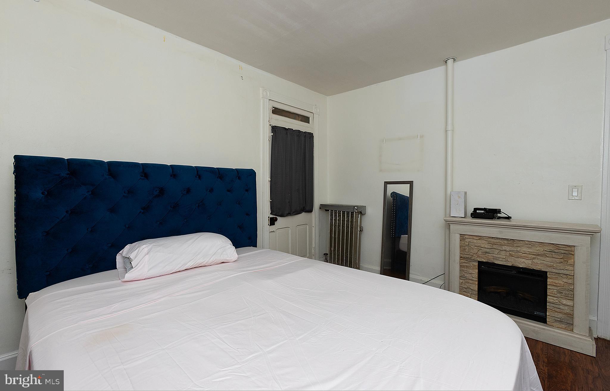 1342 State Street, Unit 2R Harrisburg, PA 17103 - Photo 14 of 17 a bedroom with a large bed and a fireplace