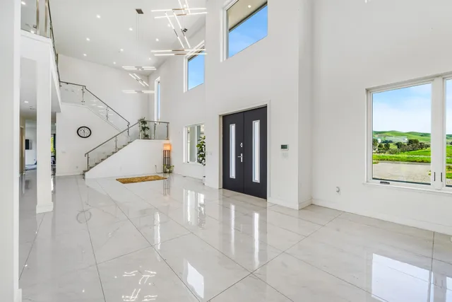 a view of a hallway with couch and a chandelier