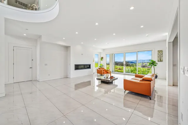 a large kitchen with kitchen island a sink a counter top space and stainless steel appliances