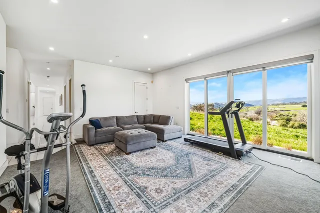 a spacious bedroom with a bed and large window