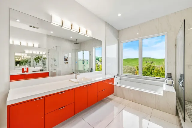 a bathroom with a double vanity sink toilet and a mirror