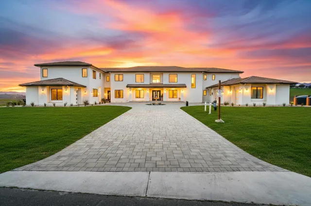 a front view of house with yard and green space