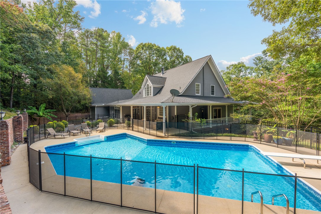 320 Watson Road Easley, SC 29642 - Photo 44 of 50 A sparkling swimming pool sits adjacent to this classic home surrounded by lush trees.