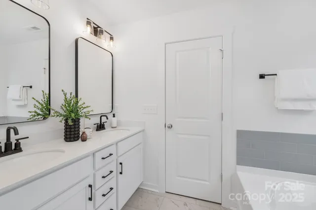 a bathroom with cabinets a sink and a mirror