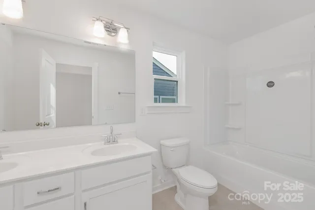 a bathroom with a sink toilet vanity and shower
