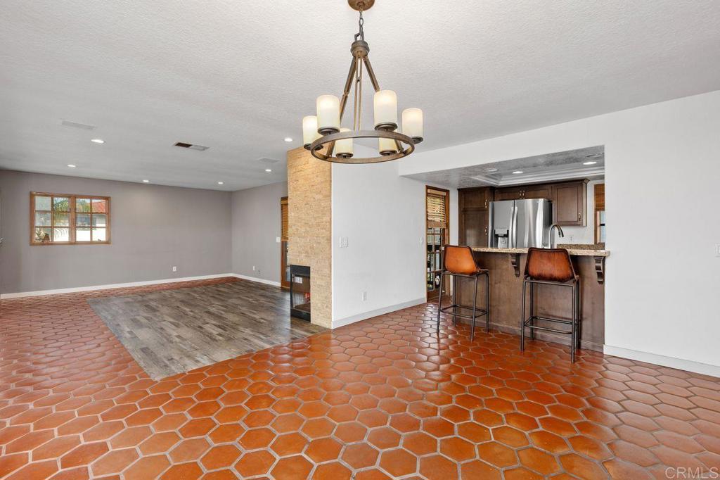 406 Paseo Pacifica Encinitas, CA 92024 - Photo 12 of 53 a view of a room with wooden floor windows and a chandelier