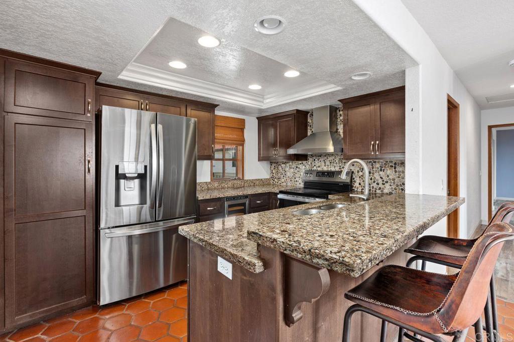 406 Paseo Pacifica Encinitas, CA 92024 - Photo 15 of 53 a kitchen with stainless steel appliances granite countertop a refrigerator and a stove top oven