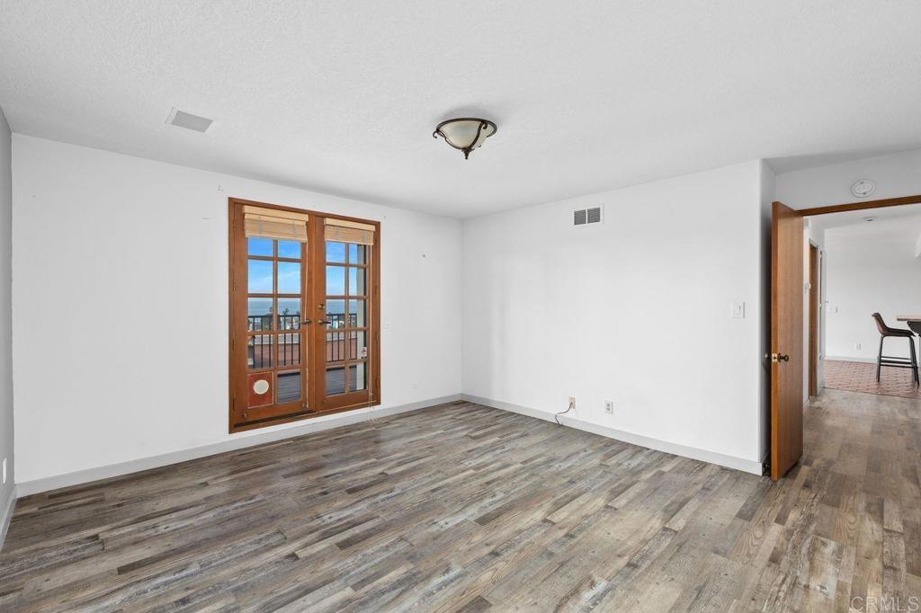 406 Paseo Pacifica Encinitas, CA 92024 - Photo 20 of 53 an empty room with wooden floor and windows