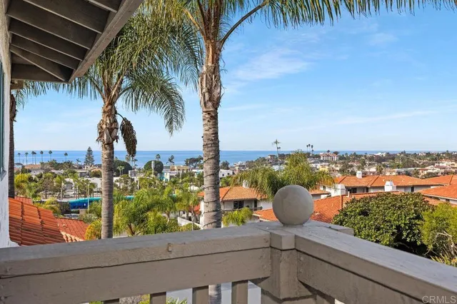 a balcony with wooden floor and city view