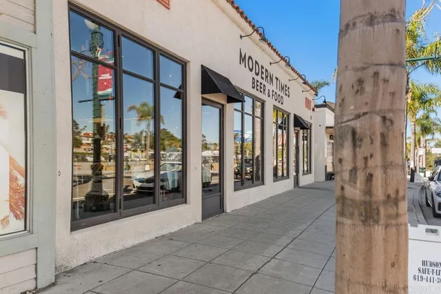 a view of a patio with a table and chairs under an umbrella