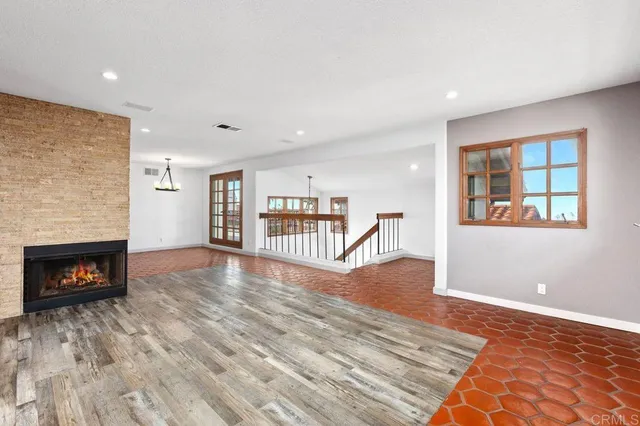 a view of a livingroom with wooden floor and a fireplace