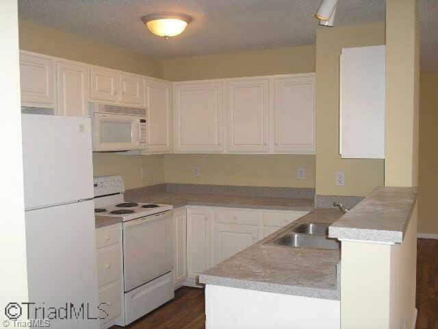 412 Timberline Ridge Court Winston-Salem, NC 27106 - Photo 5 of 9 Other. Bright kitchen with laminate flooring, white cabinetry and white appliances!
