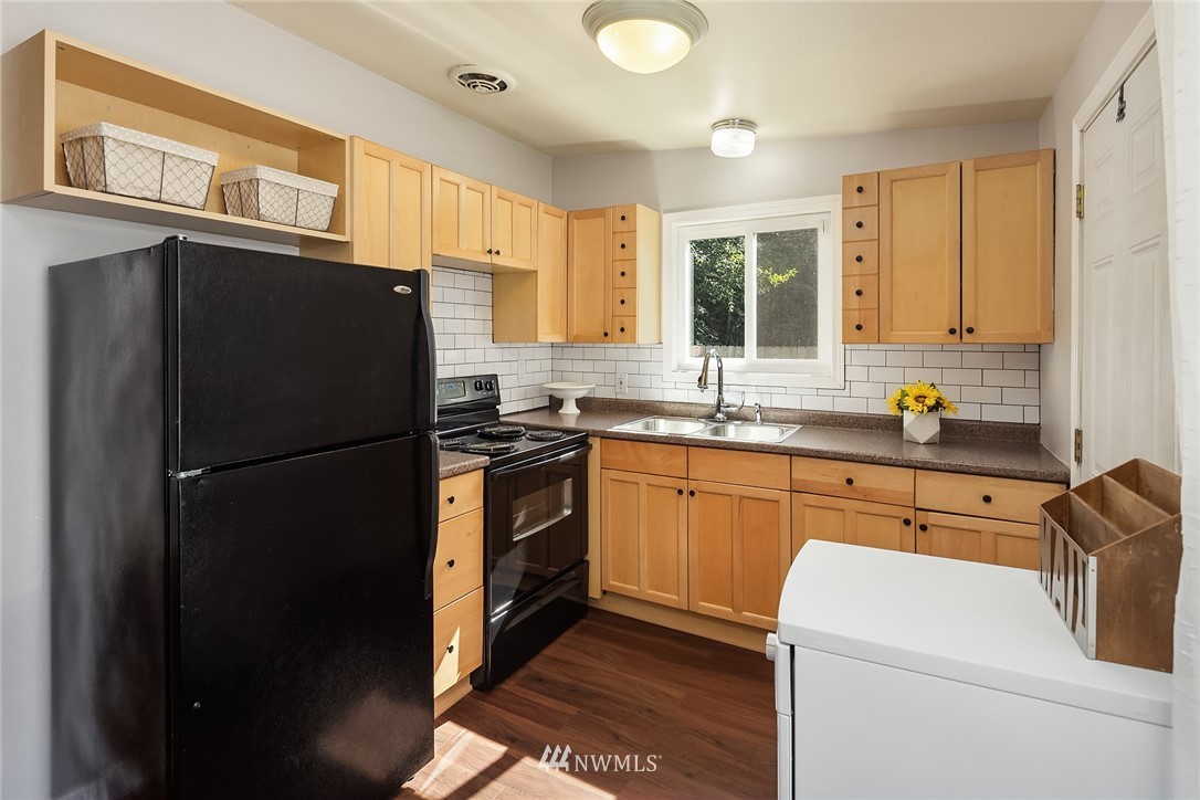 22519 Southeast Bain Road Maple Valley, WA 98038 - Photo 4 of 15 a kitchen with a refrigerator and a sink