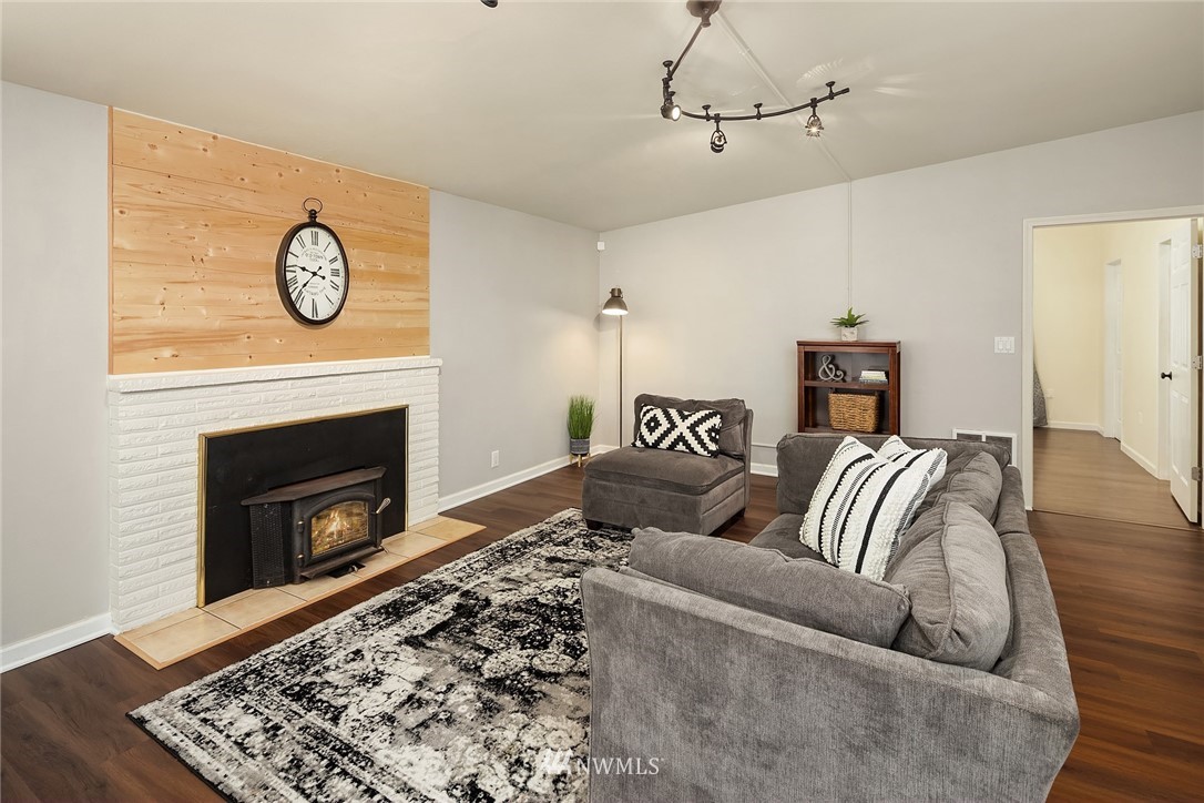 22519 Southeast Bain Road Maple Valley, WA 98038 - Photo 5 of 15 a living room with furniture a fireplace and wooden floor