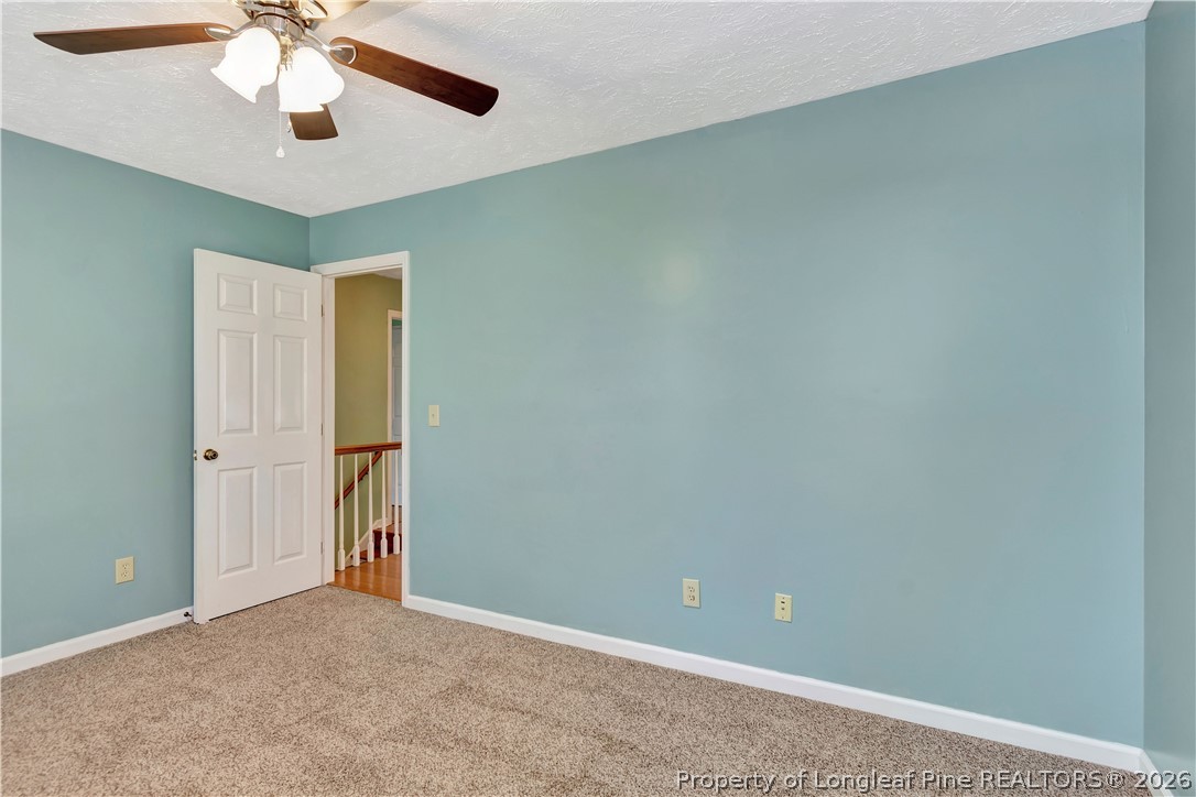 532 Blackbird Road Fayetteville, NC 28314 - Photo 25 of 38 an empty room with chandelier fan and windows