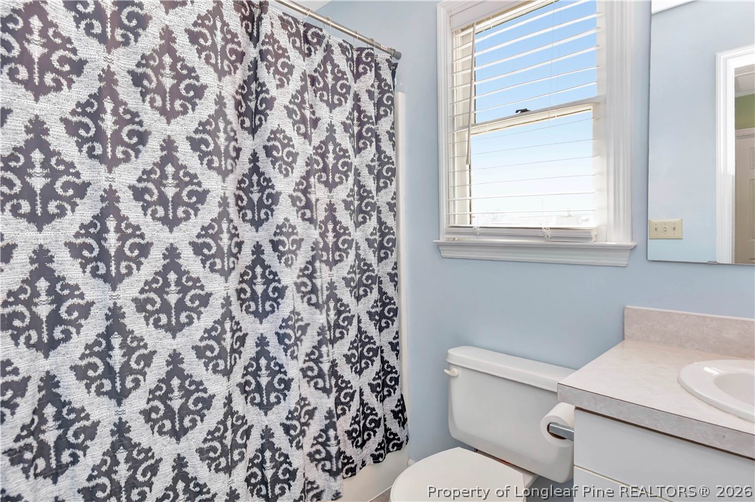 532 Blackbird Road Fayetteville, NC 28314 - Photo 26 of 38 a white toilet sitting next to a bathroom sink