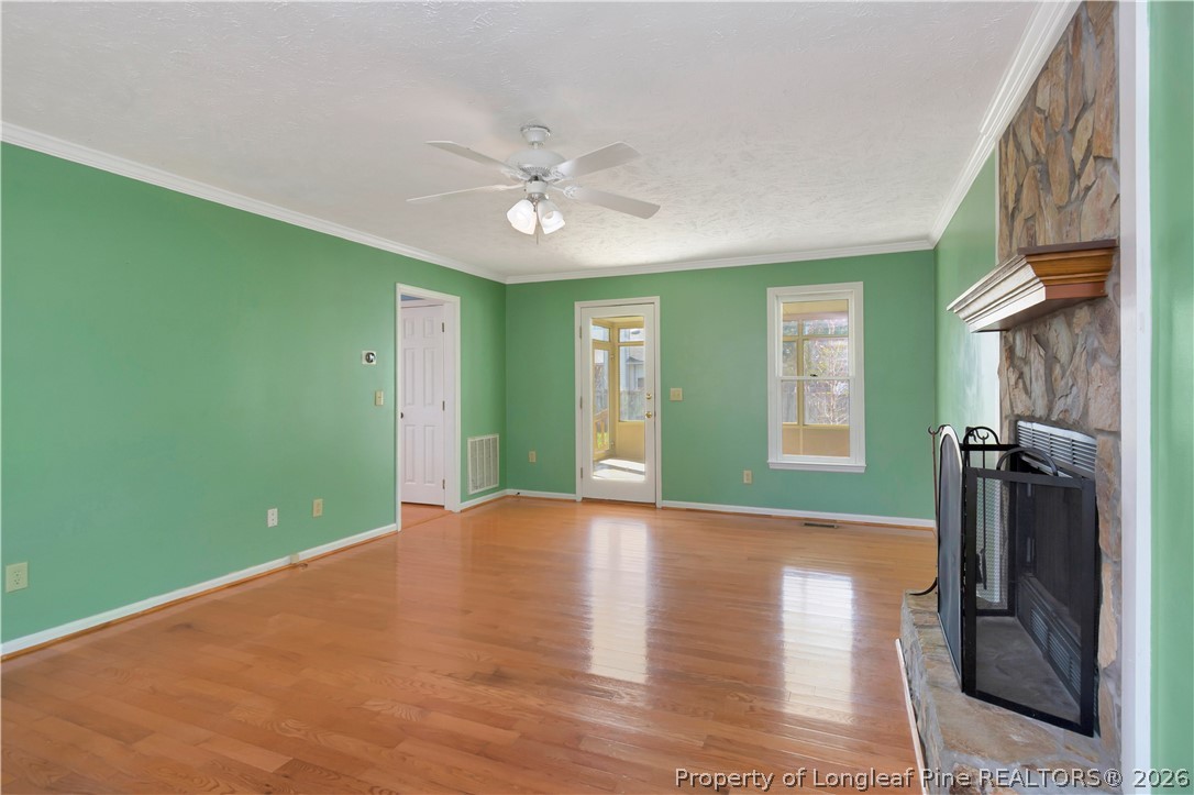 532 Blackbird Road Fayetteville, NC 28314 - Photo 8 of 38 a view of a livingroom with a hardwood floor and a ceiling fan
