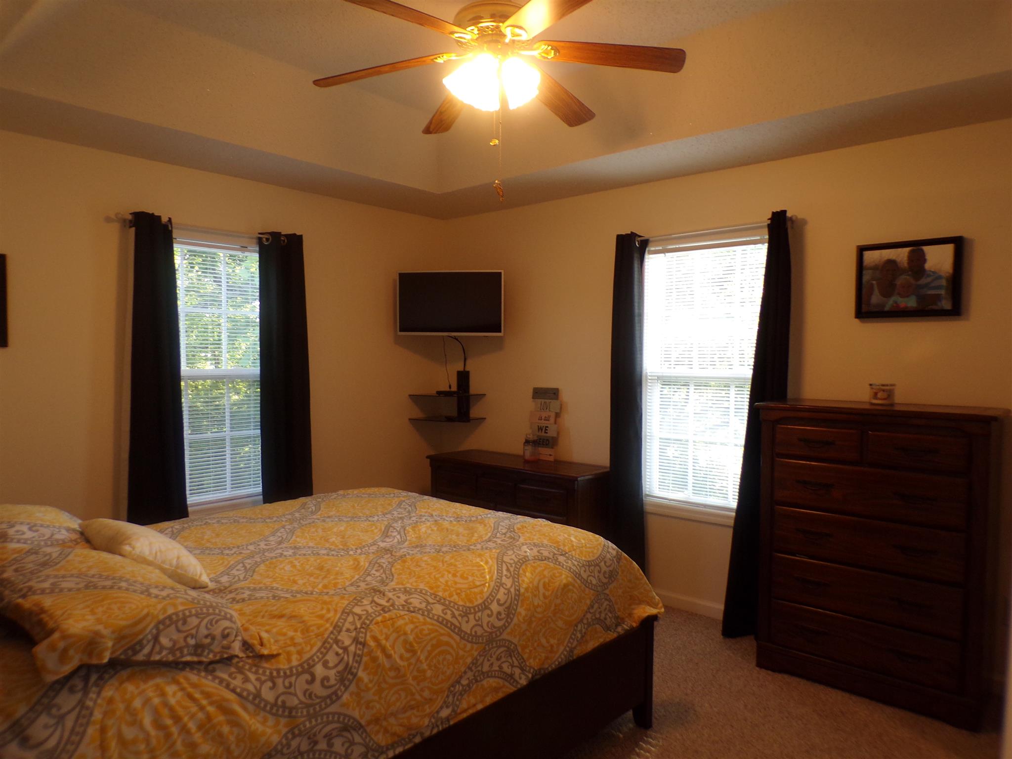 1190 Rhotons Chapel Road Manchester, TN 37355 - Photo 11 of 27 a bedroom with a bed and a flat tv screen on dresser
