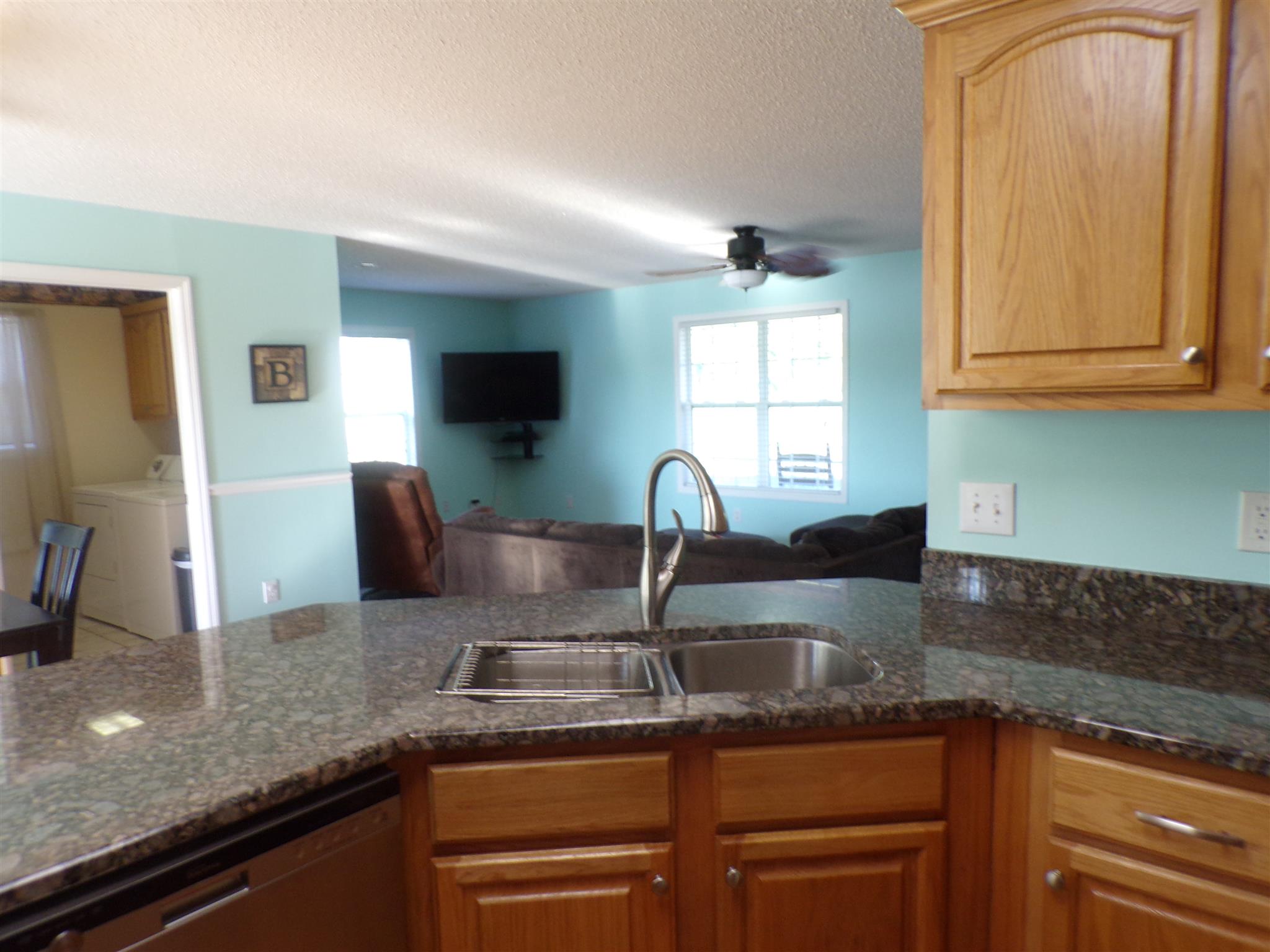 1190 Rhotons Chapel Road Manchester, TN 37355 - Photo 6 of 27 a kitchen with granite countertop a sink a counter top space cabinets and stainless steel appliances