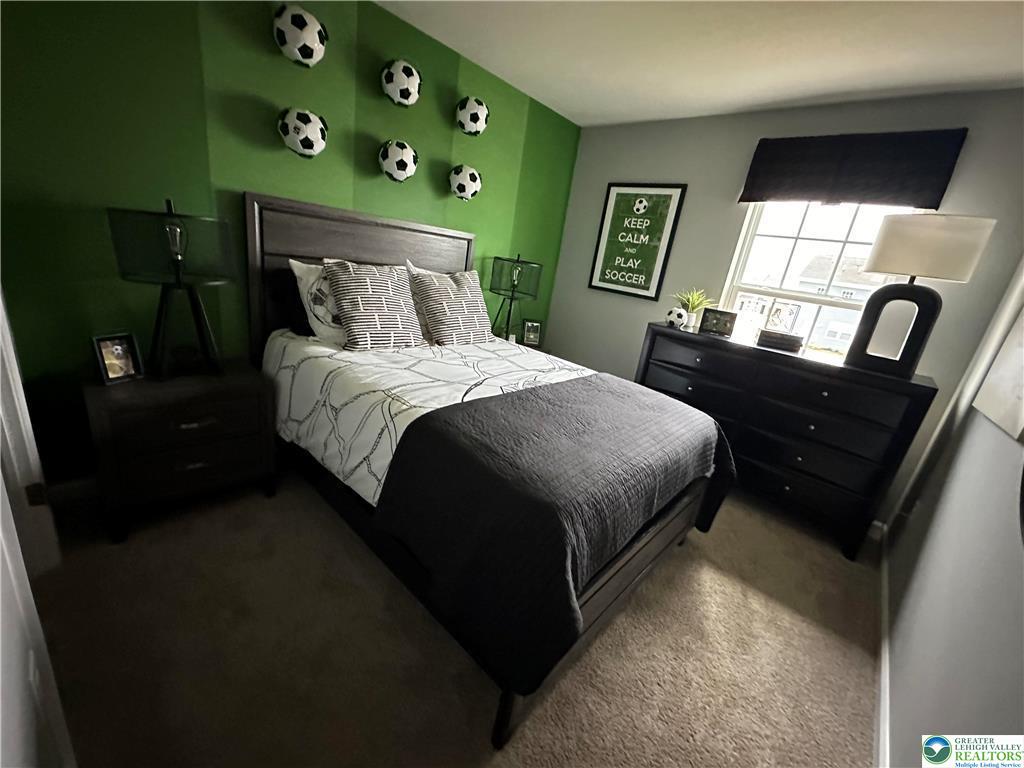 1145 Martin Road Breinigsville, PA 18031 - Photo 19 of 38 A well-lit bedroom features plush carpeting and a large window providing natural light.