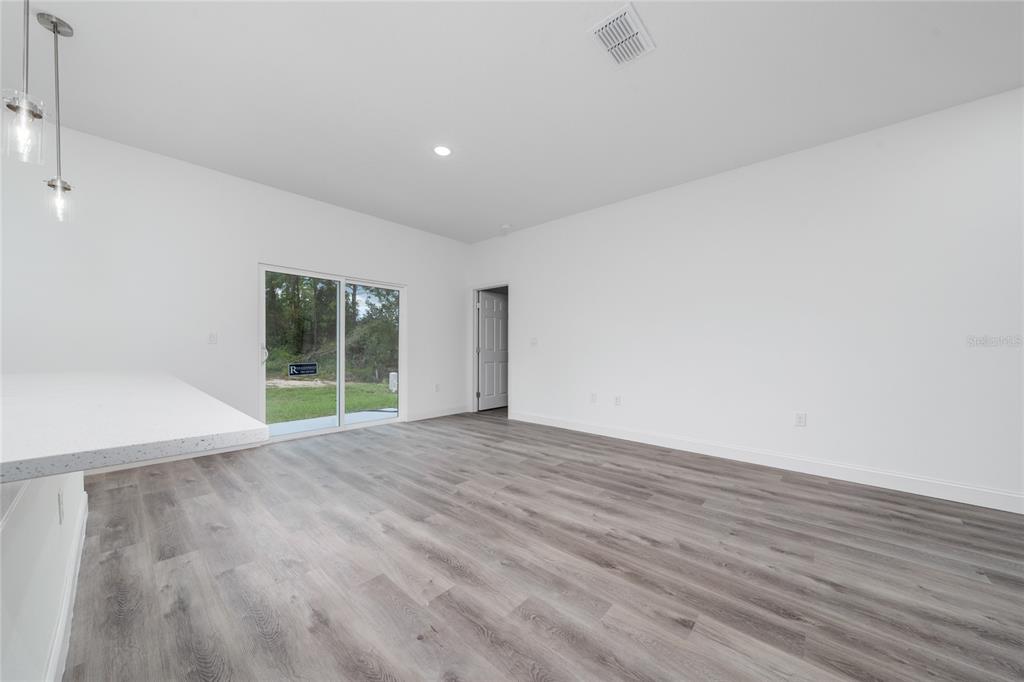 13069 Southwest 35th Circle Ocala, FL 34473 - Photo 13 of 41 a view of an empty room with wooden floor and a window