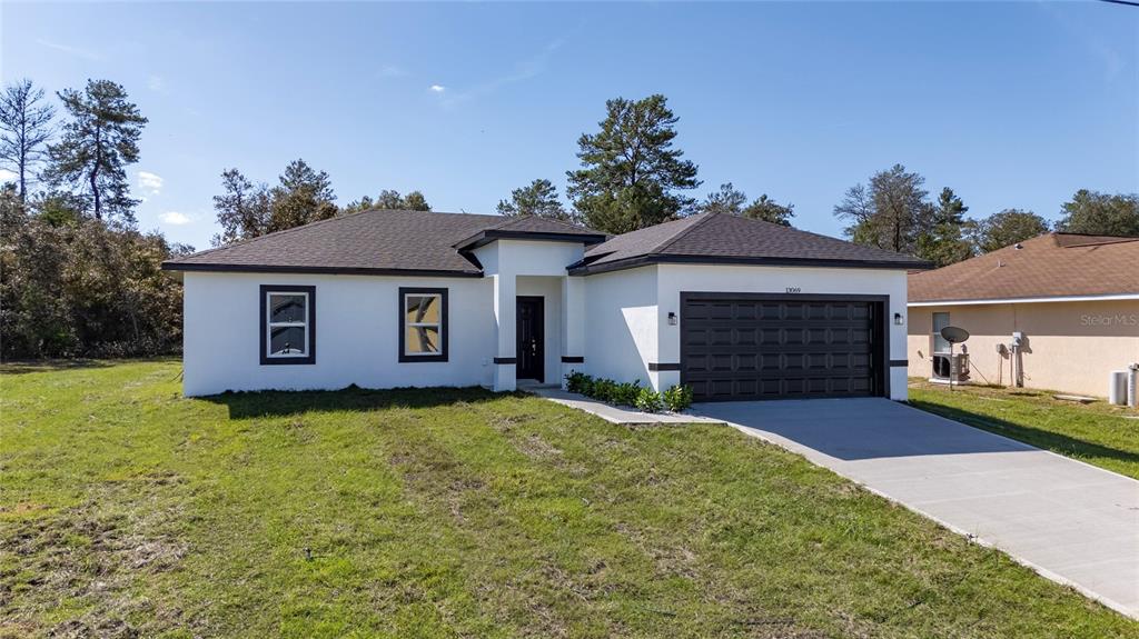 13069 Southwest 35th Circle Ocala, FL 34473 - Photo 35 of 41 a view of a yard in front of a house with a large tree