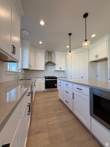 1142 West 220 North Mapleton, UT 84664 - Photo 2 of 26 Kitchen with white cabinetry, stainless steel electric range, light stone countertops, pendant lighting, and light wood finished floors