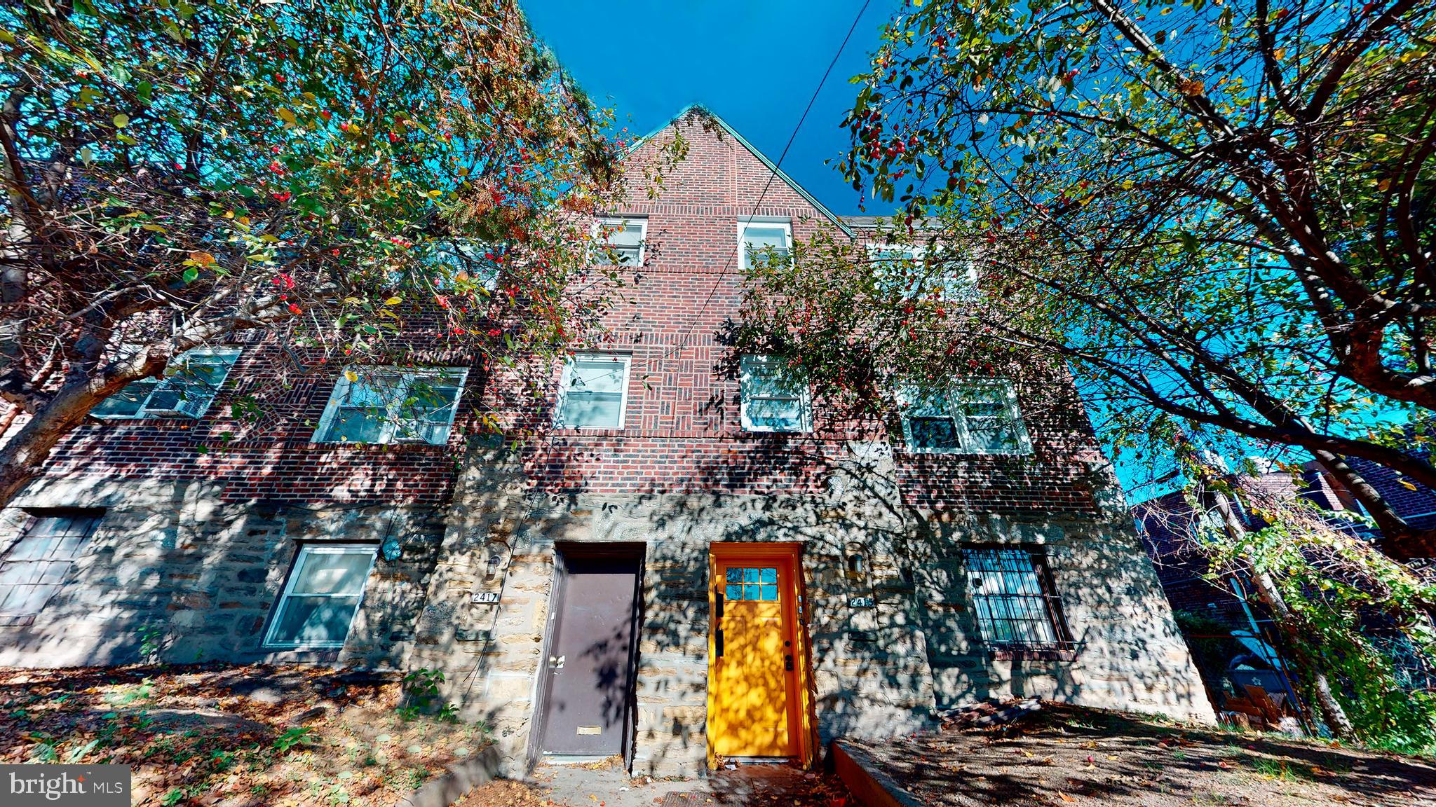 2415 80th Avenue Philadelphia, PA 19150 - Photo 1 of 15 a aerial view of a house with a yard and large trees