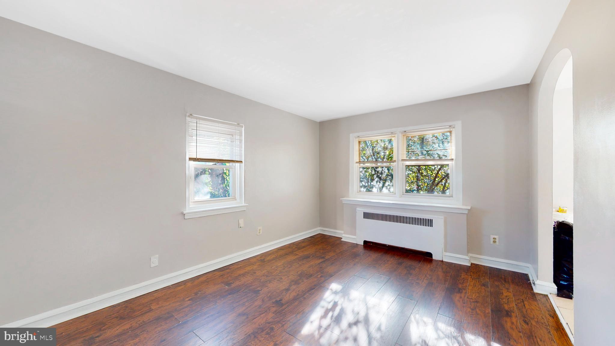2415 80th Avenue Philadelphia, PA 19150 - Photo 4 of 15 an empty room with wooden floor and windows