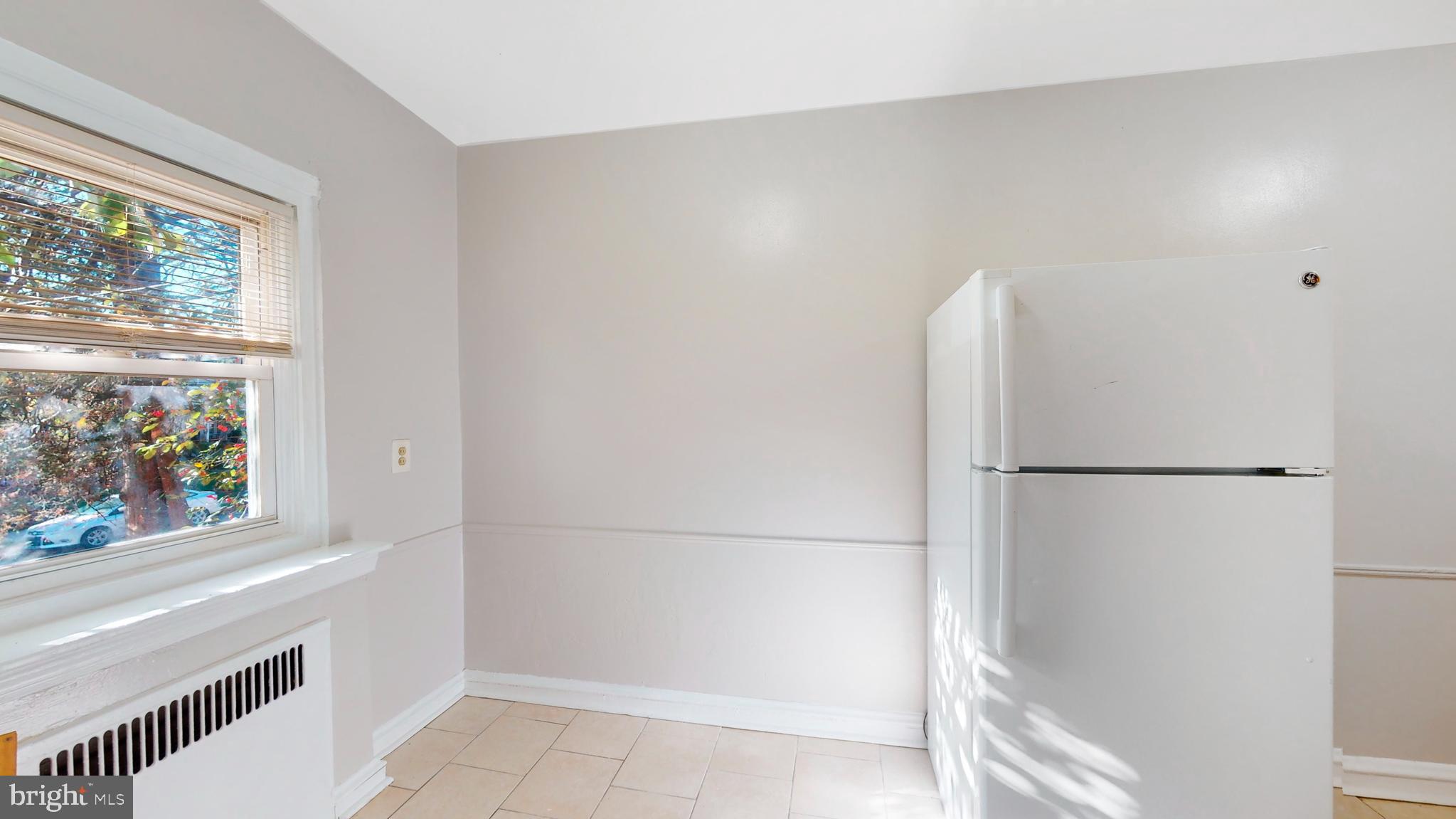 2415 80th Avenue Philadelphia, PA 19150 - Photo 7 of 15 a white refrigerator freezer and a stove sitting inside of a kitchen
