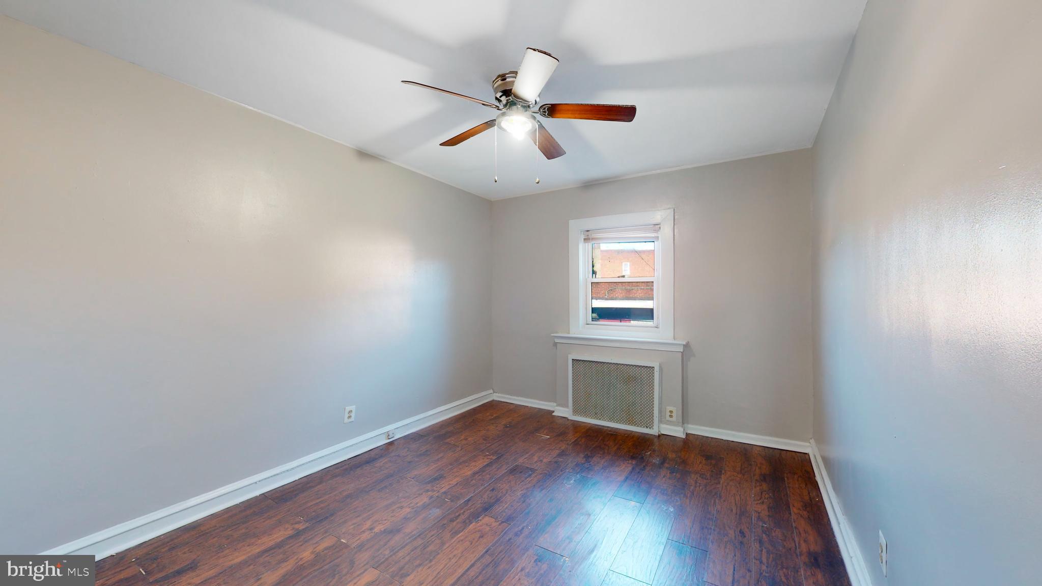 2415 80th Avenue Philadelphia, PA 19150 - Photo 8 of 15 an empty room with wooden floor and windows