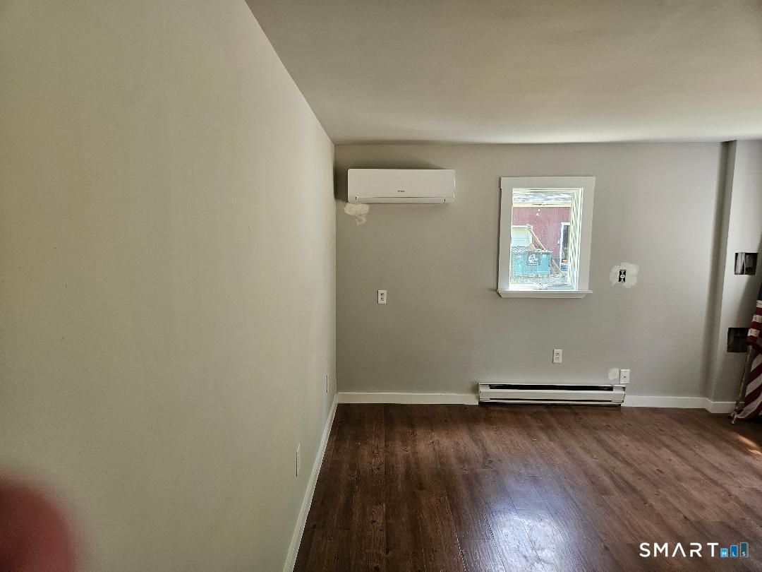 300 Railtree Hill Road Woodbury, CT 06798 - Photo 4 of 7 an empty room with wooden floor and windows