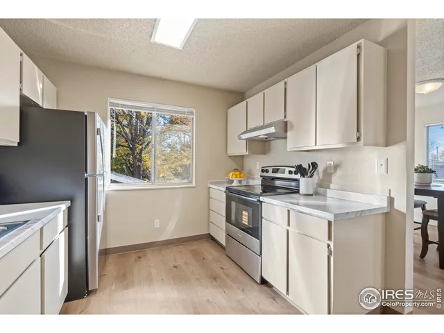 a kitchen with stainless steel appliances granite countertop a stove a sink dishwasher and a refrigerator