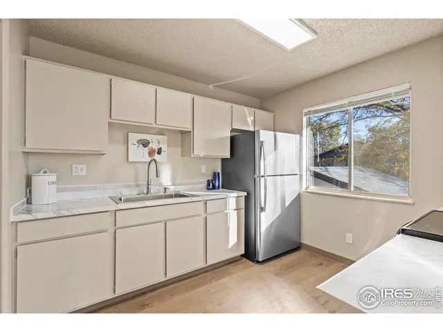 a kitchen with stainless steel appliances a refrigerator sink and cabinets