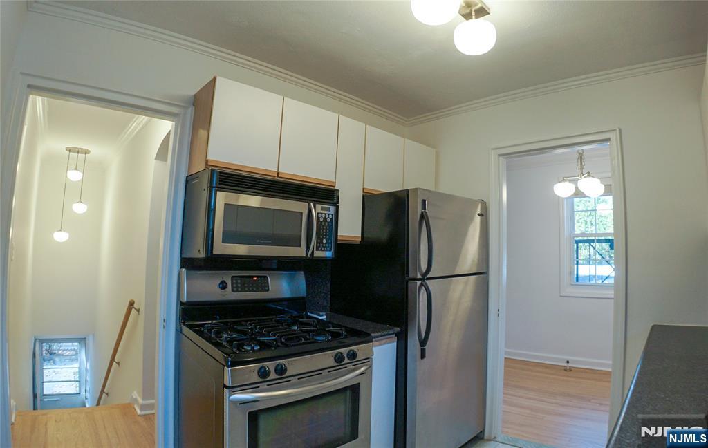 63 West Hudson Avenue, Unit C5 Englewood, NJ 07631 - Photo 11 of 19 a kitchen with a refrigerator stove and microwave