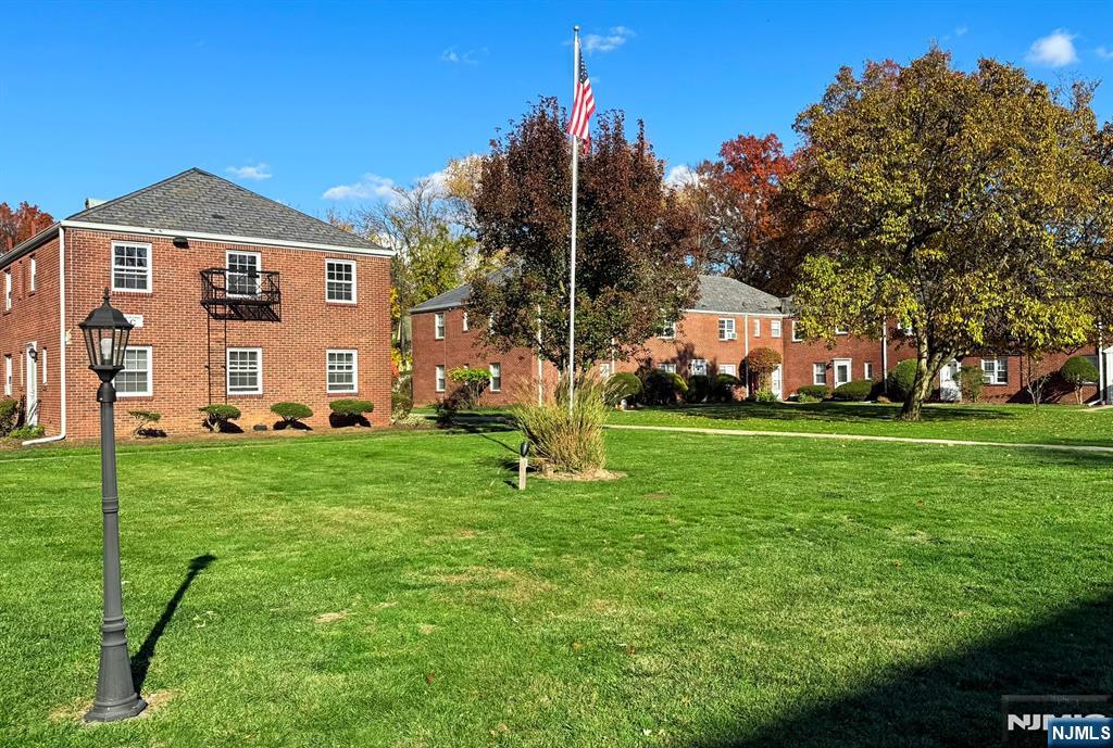 63 West Hudson Avenue, Unit C5 Englewood, NJ 07631 - Photo 19 of 19 a front view of a house with a yard
